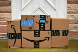 Amazon boxes piled neatly in front of someone’s front door